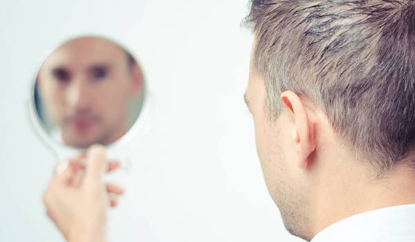 man looking in mirror